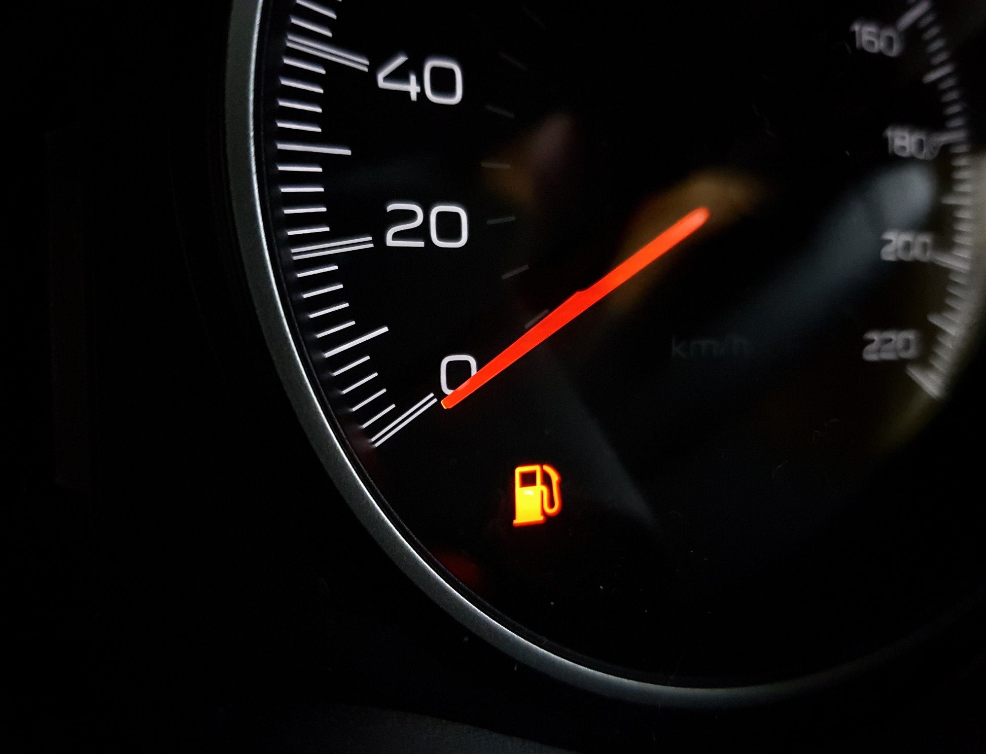 Close-up image of Low fuel lamp on dashboard in car.