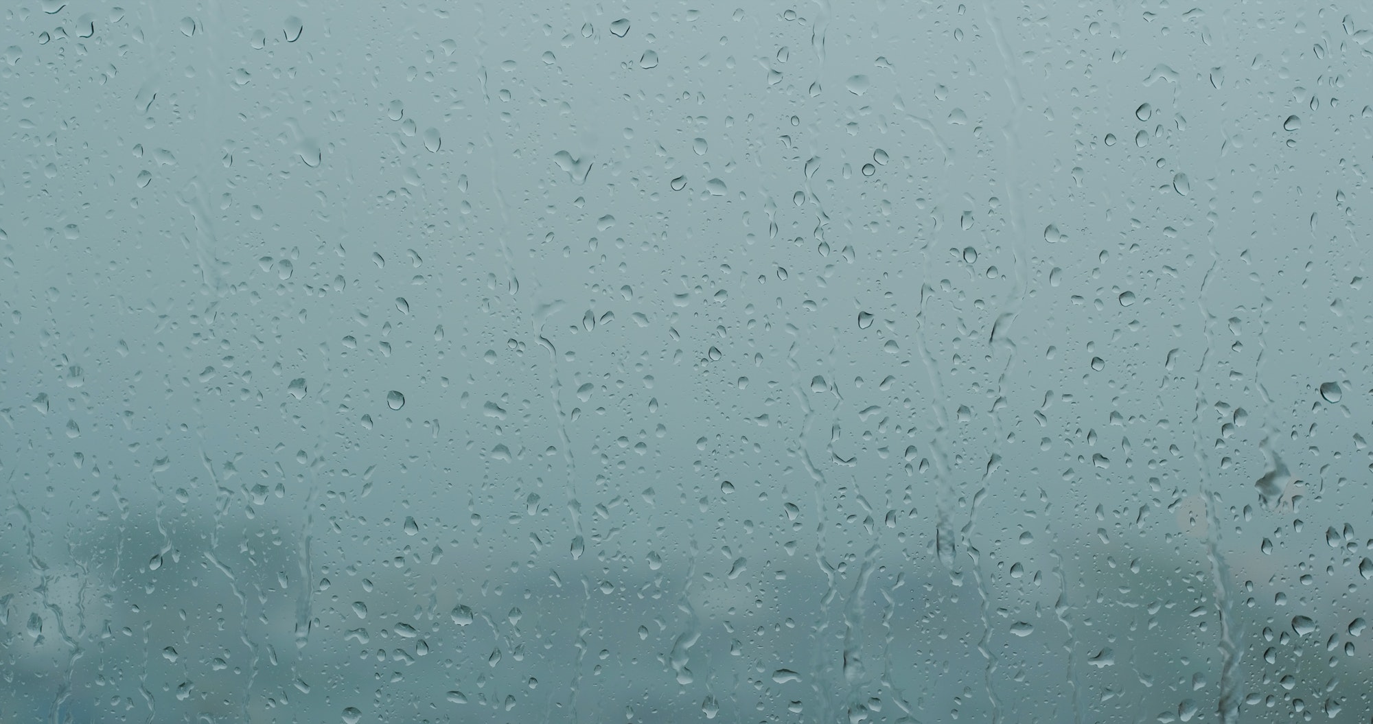 Heavy raining outside, rain on the window glass
