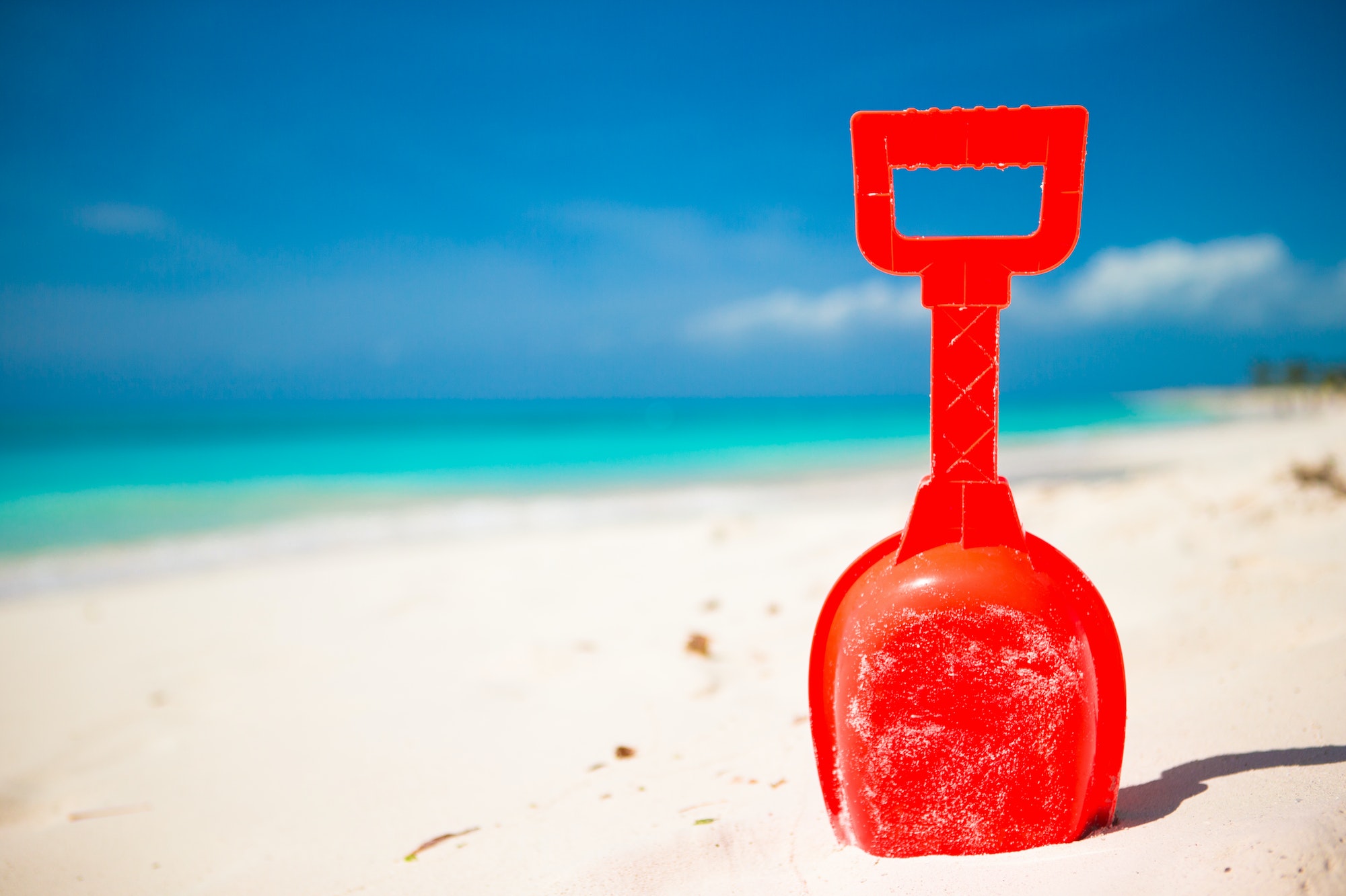 Summer kid's beach toy in the white sand