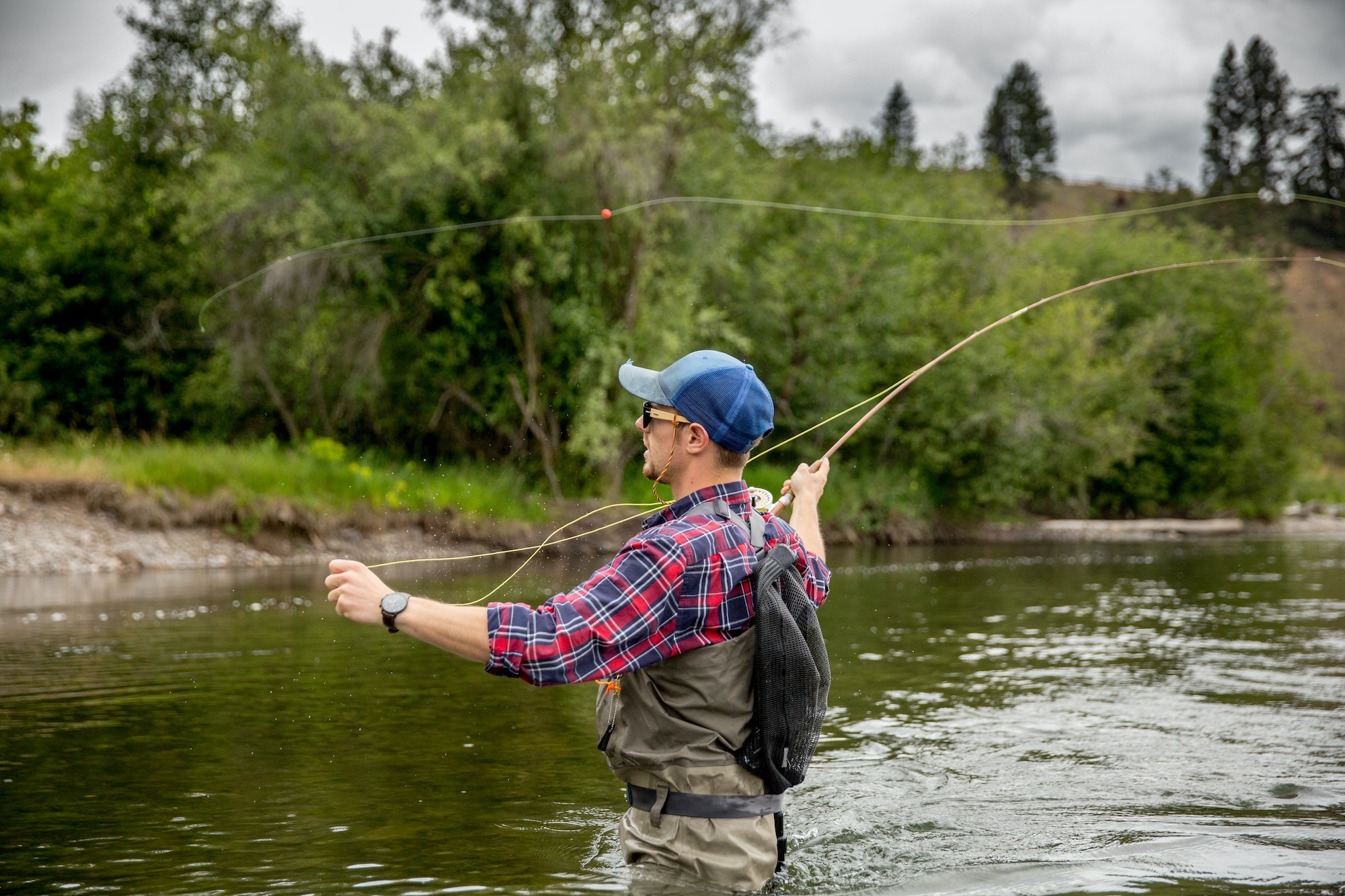 Man fishing in river, Clark Fork, Montana and Idaho, US