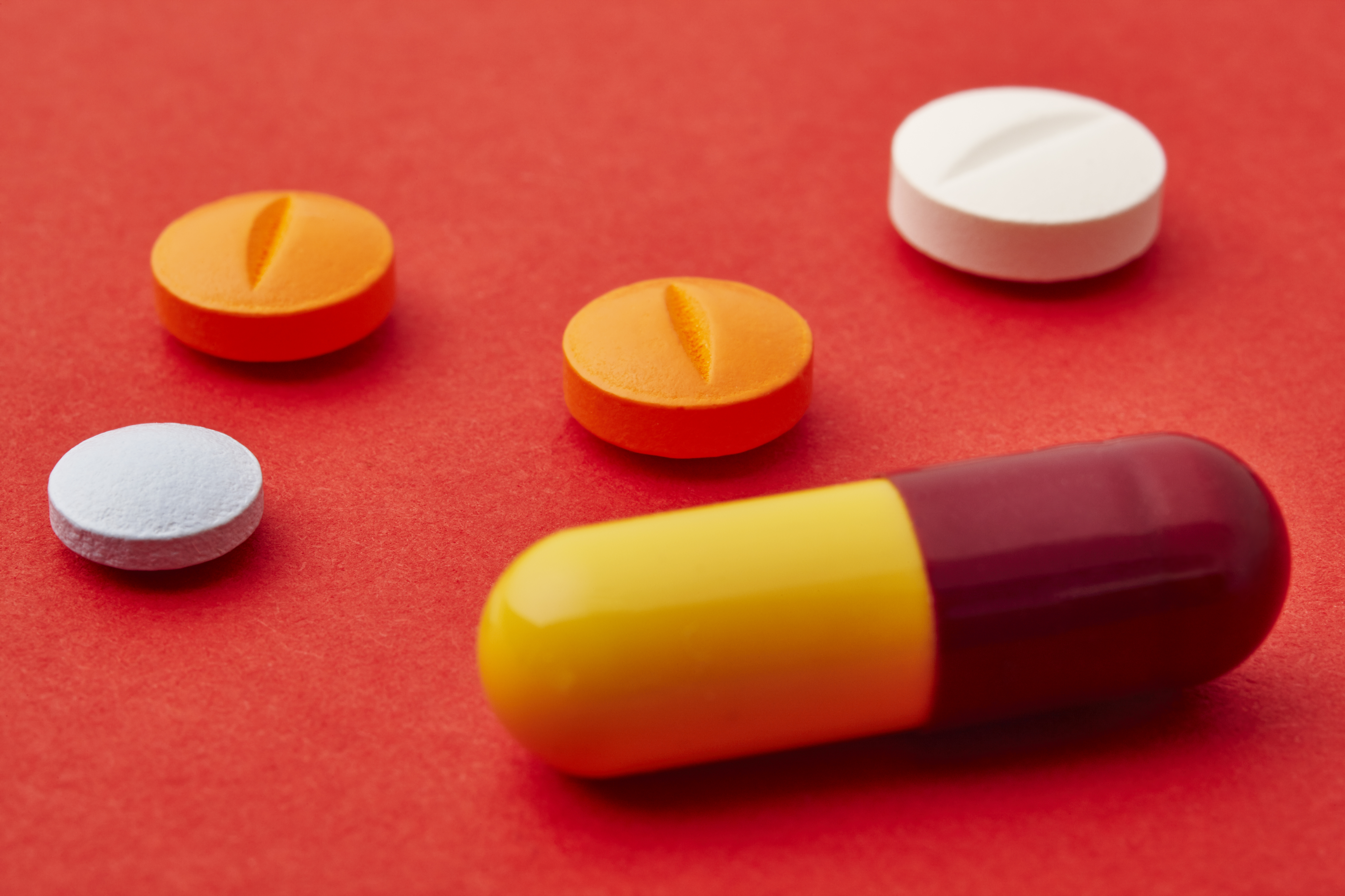 Pills over a red background. Medicament treatment. Health care photo